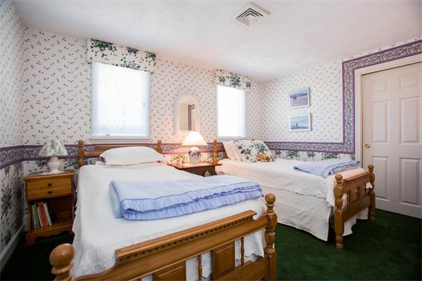 85 Myles Standish Road Weston, MA 02493 - Photo 25 of 28 a spacious bedroom with a bed and window