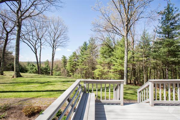 85 Myles Standish Road Weston, MA 02493 - Photo 8 of 28 a view of a wooden deck with trees