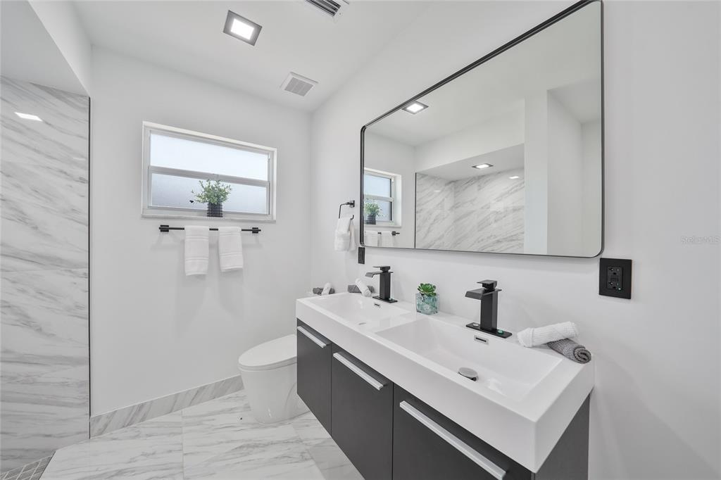 2166 Beacon Drive Port Charlotte, FL 33952 - Photo 18 of 36 a bathroom with a sink mirror and toilet