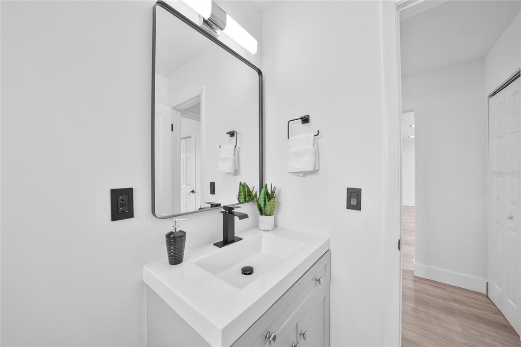 2166 Beacon Drive Port Charlotte, FL 33952 - Photo 23 of 36 a bathroom with a sink and a mirror