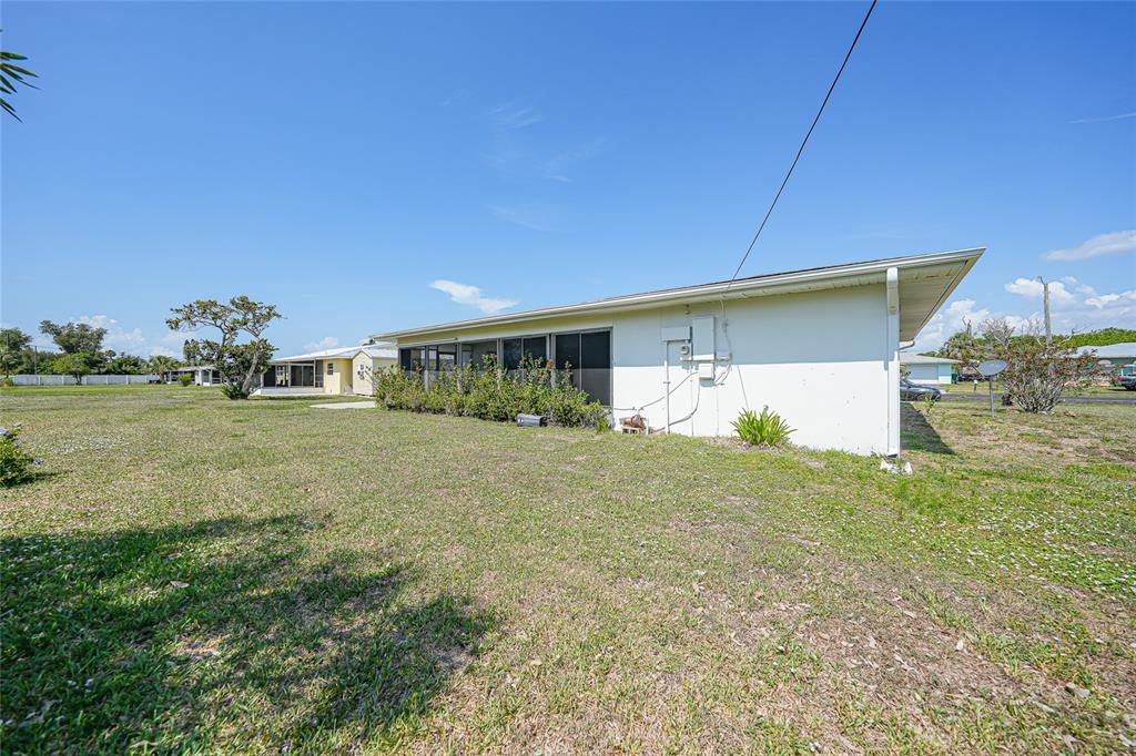 2166 Beacon Drive Port Charlotte, FL 33952 - Photo 29 of 36 a view of a house with backyard and garden