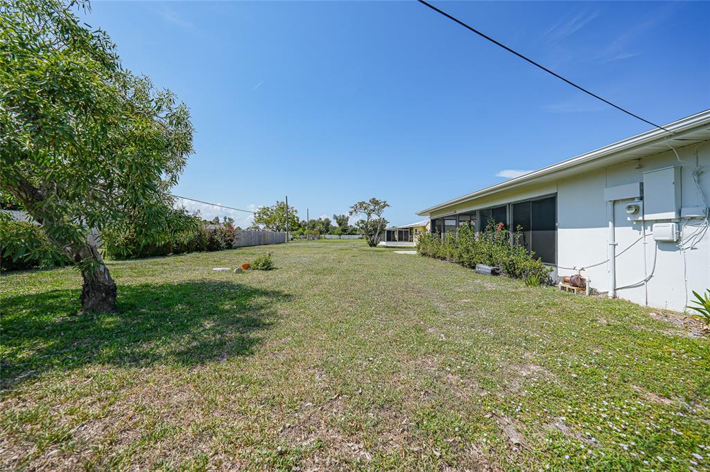 2166 Beacon Drive Port Charlotte, FL 33952 - Photo 31 of 36 a backyard of a house with table and chairs