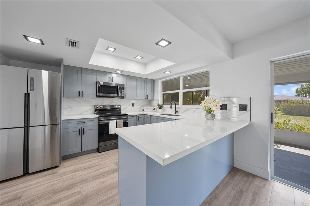 2166 Beacon Drive Port Charlotte, FL 33952 - Photo 10 of 36 a kitchen with a sink stainless steel appliances and counter space