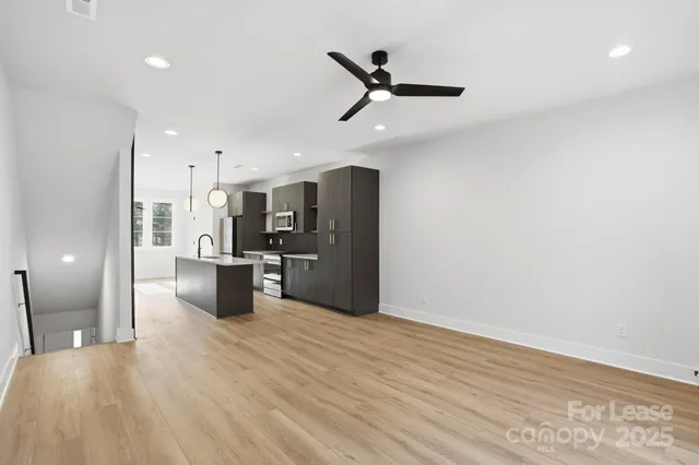 a view of a kitchen with a sink and stainless steel appliances
