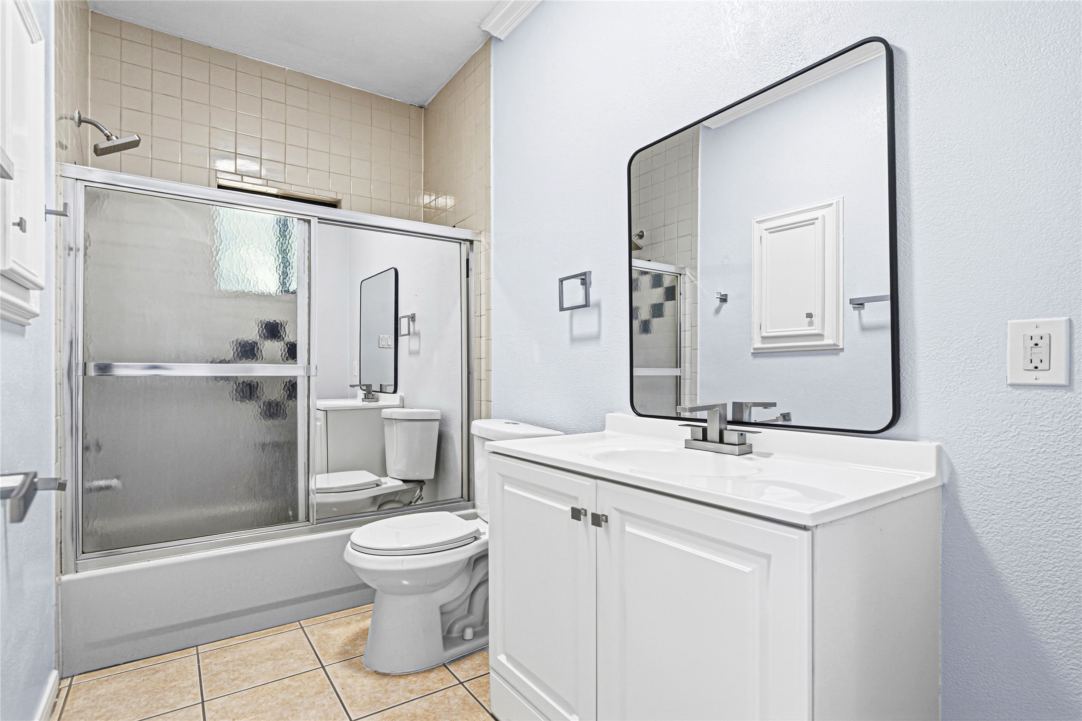 7839 Goode Street, Unit B Houston, TX 77012 - Photo 8 of 11 a bathroom with a granite countertop sink toilet a mirror and shower
