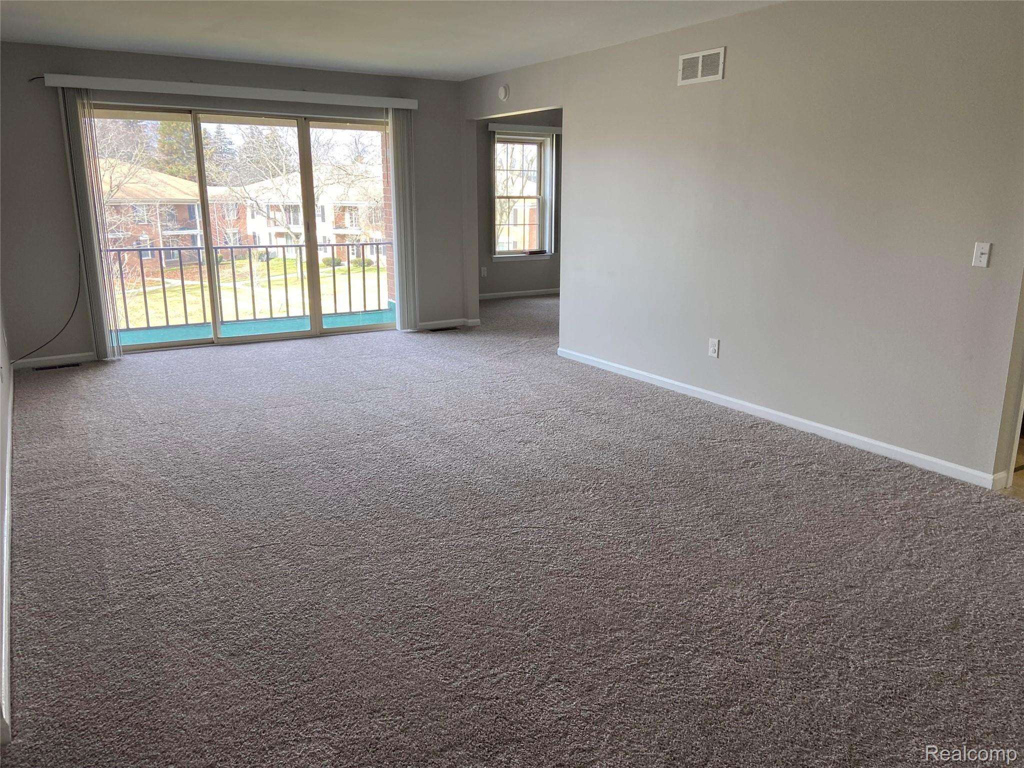 29644 Middlebelt Road, Unit 54 Farmington, MI 48334 - Photo 18 of 31 Sliding glass door off living room leads you to your private balcony