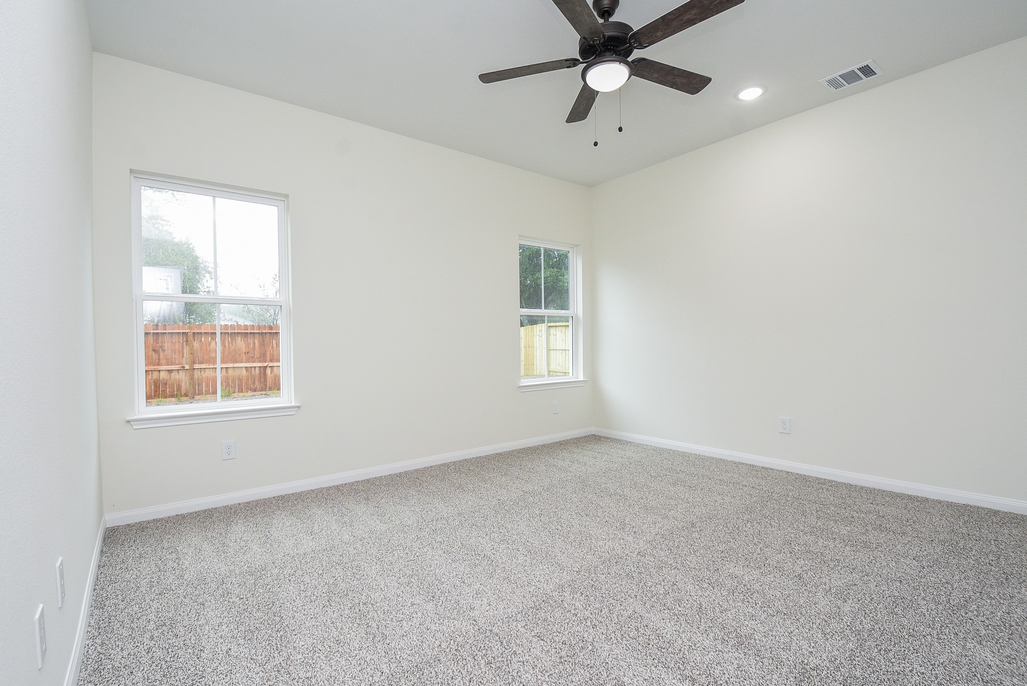 2807 Topiary Lane Houston, TX 77014 - Photo 20 of 32 an empty room with a window and a fan