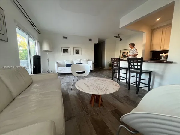 a kitchen with kitchen island a counter appliances a sink and a window