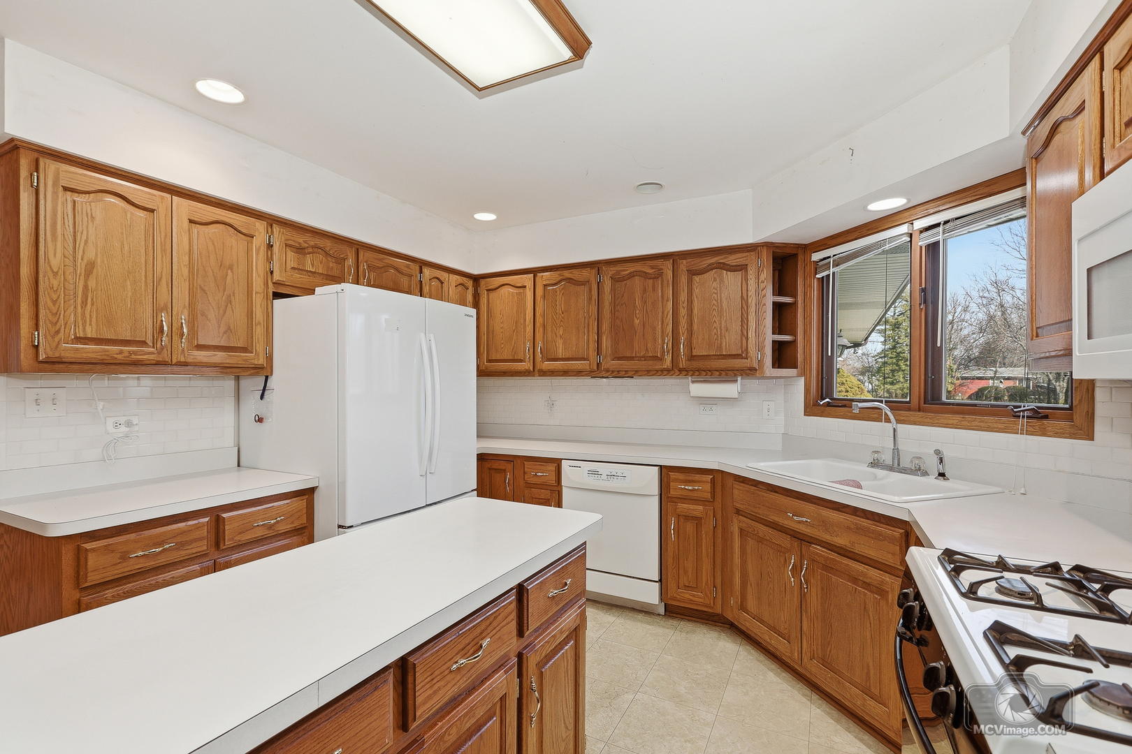 24711 South Sycamore Street Elwood, IL 60421 - Photo 11 of 38 a kitchen with a sink a stove a refrigerator and cabinets