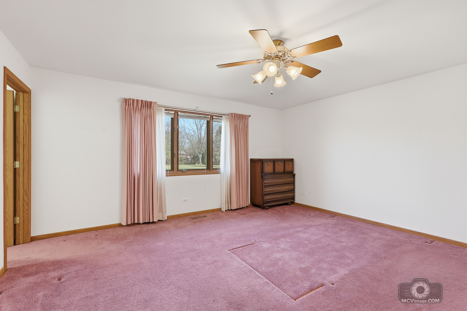 24711 South Sycamore Street Elwood, IL 60421 - Photo 18 of 38 a view of an empty room with window and a ceiling fan