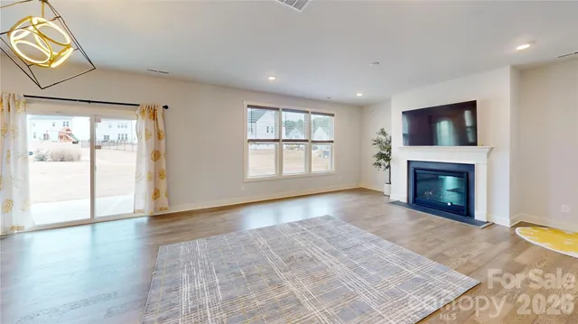 an empty room with windows and a fireplace