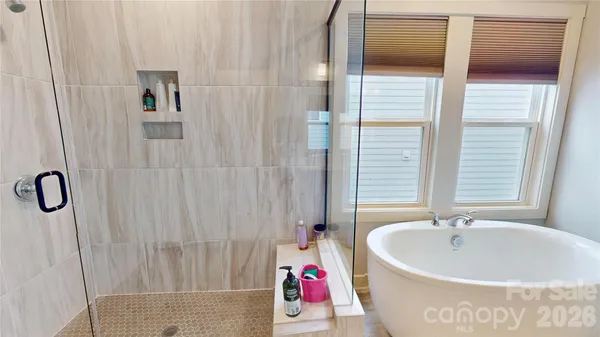 a bathroom with a bathtub and shower
