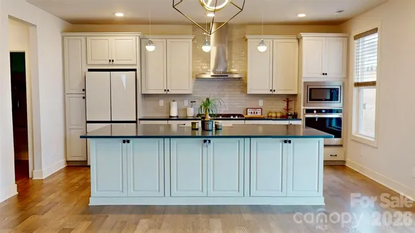 a kitchen with stainless steel appliances granite countertop a refrigerator sink and cabinets