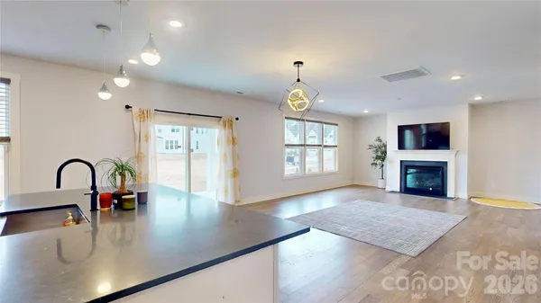 a view of a kitchen with a sink and a fireplace