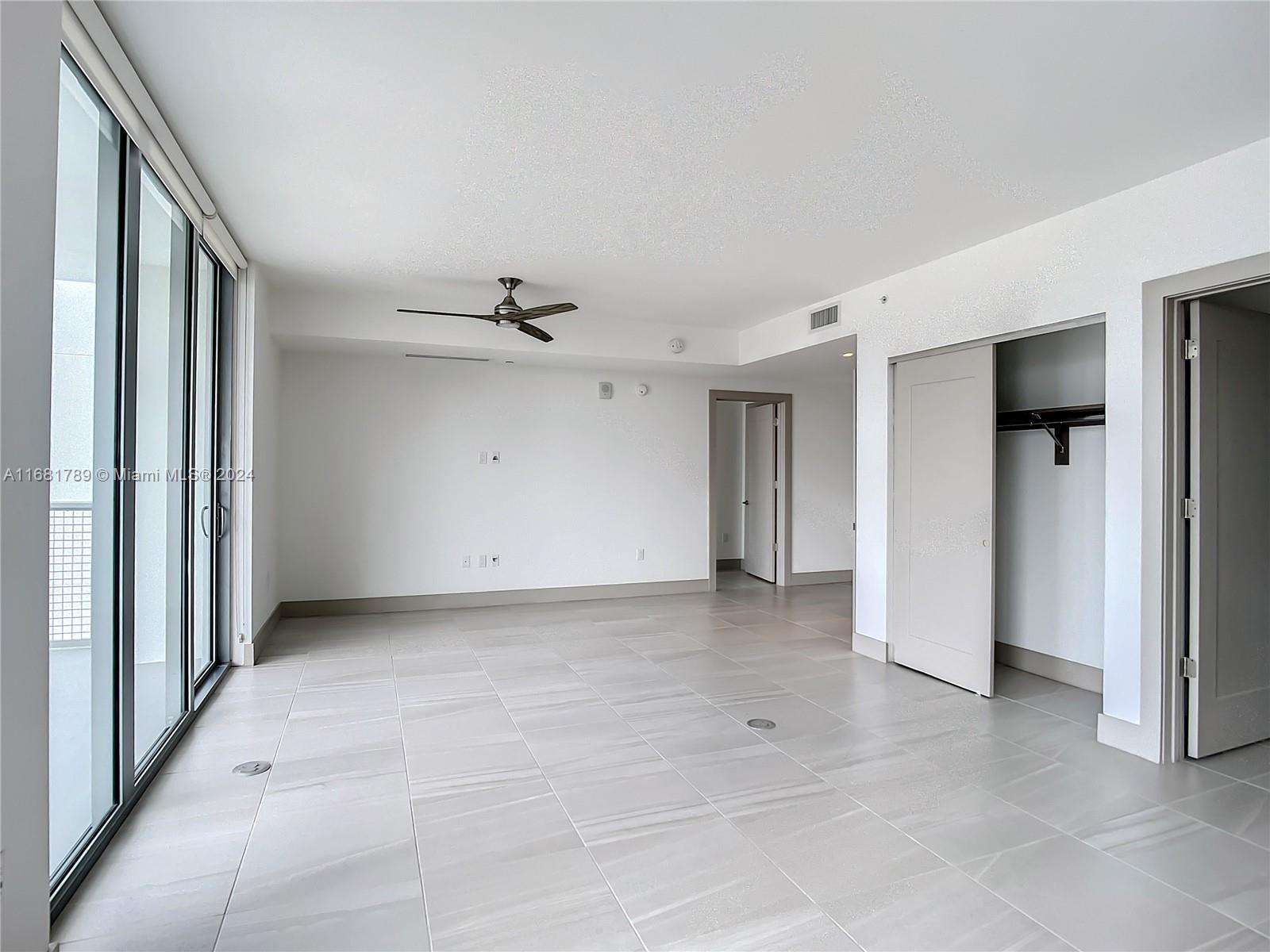 340 Southeast 3rd Street, Unit 1802 Miami, FL 33131 - Photo 13 of 36 a view of an empty room with a window