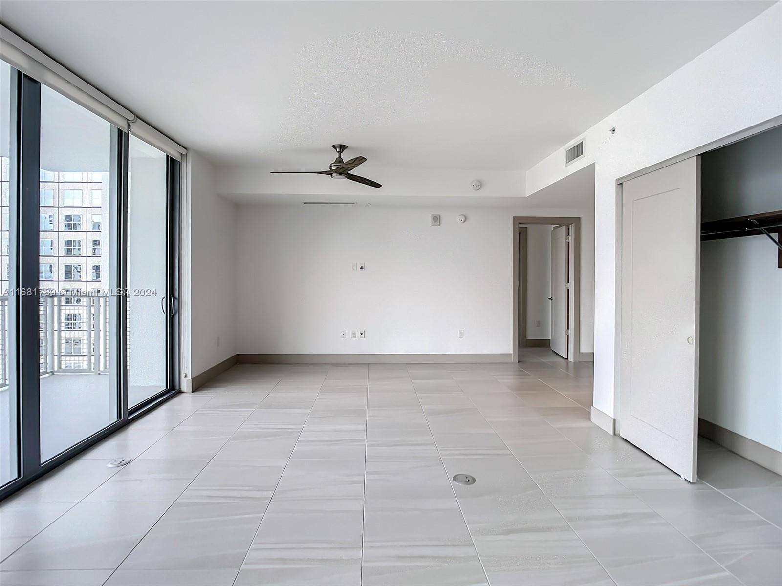 340 Southeast 3rd Street, Unit 1802 Miami, FL 33131 - Photo 14 of 36 a view of an empty room with a window