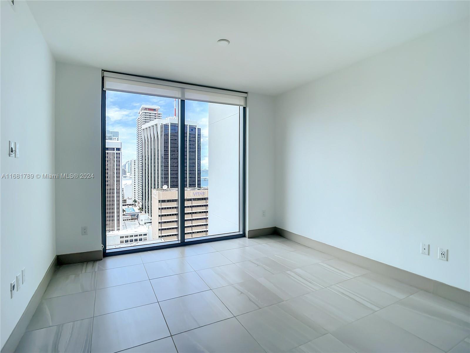 340 Southeast 3rd Street, Unit 1802 Miami, FL 33131 - Photo 21 of 36 a view of an empty room with a fireplace