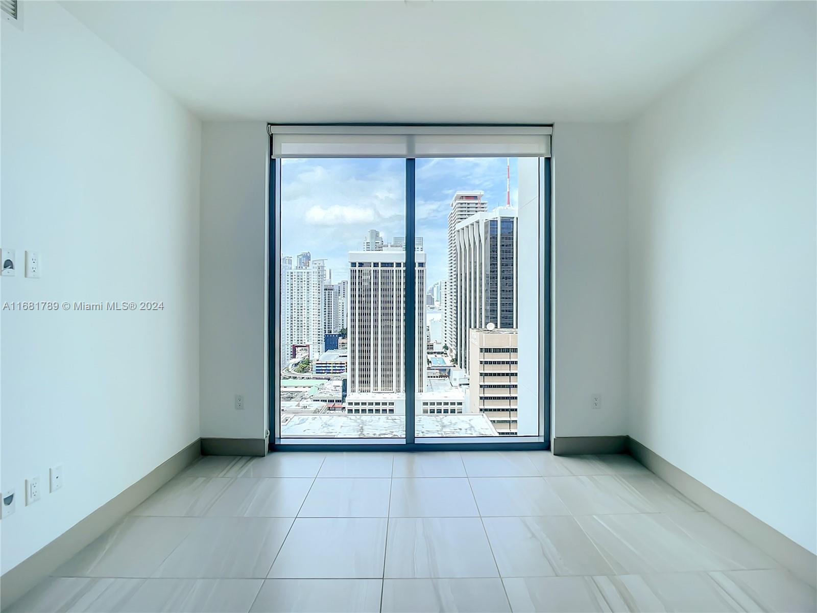 340 Southeast 3rd Street, Unit 1802 Miami, FL 33131 - Photo 22 of 36 a view of an empty room with a fireplace
