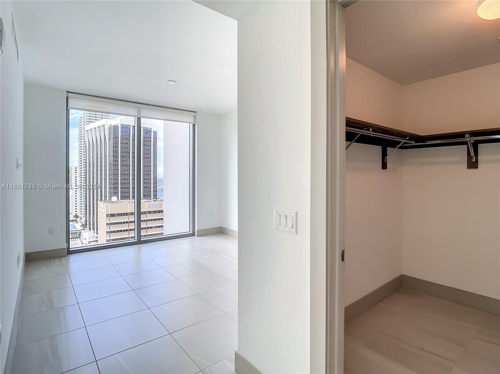 340 Southeast 3rd Street, Unit 1802 Miami, FL 33131 - Photo 24 of 36 a view of an empty room with a window