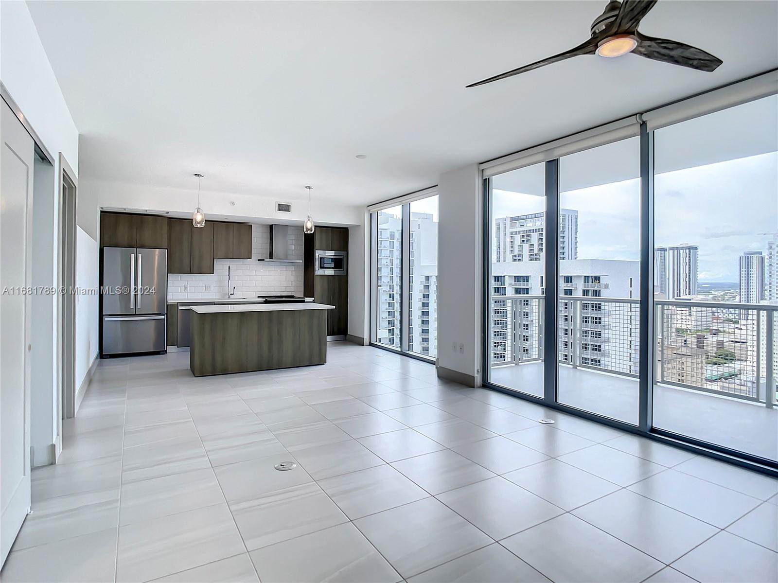 340 Southeast 3rd Street, Unit 1802 Miami, FL 33131 - Photo 5 of 36 a large kitchen with a cabinets and outdoor view