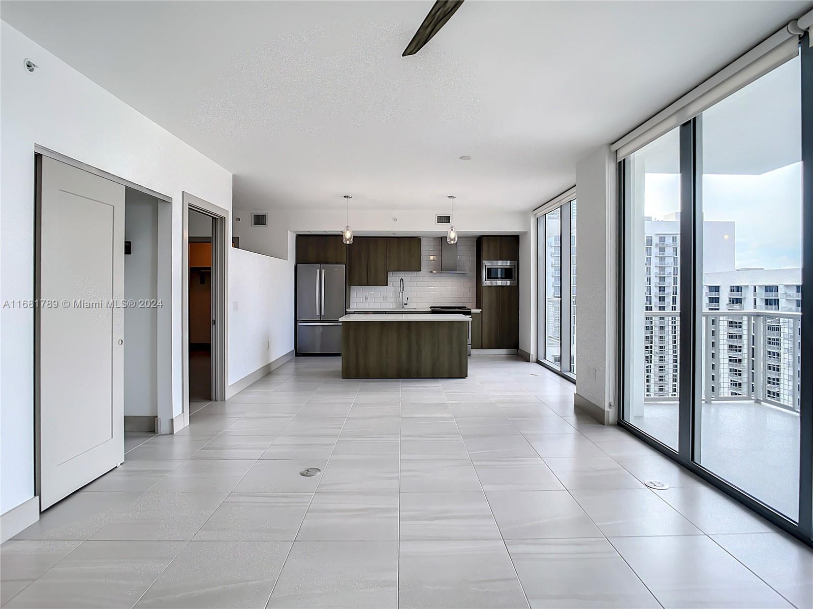 340 Southeast 3rd Street, Unit 1802 Miami, FL 33131 - Photo 6 of 36 a large bathroom with a large mirror vanity and shower