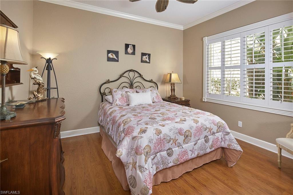 377 Mallory Court Naples, FL 34110 - Photo 16 of 29 a bedroom with a bed and a large window