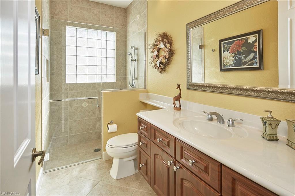 377 Mallory Court Naples, FL 34110 - Photo 17 of 29 a bathroom with a sink a toilet and shower