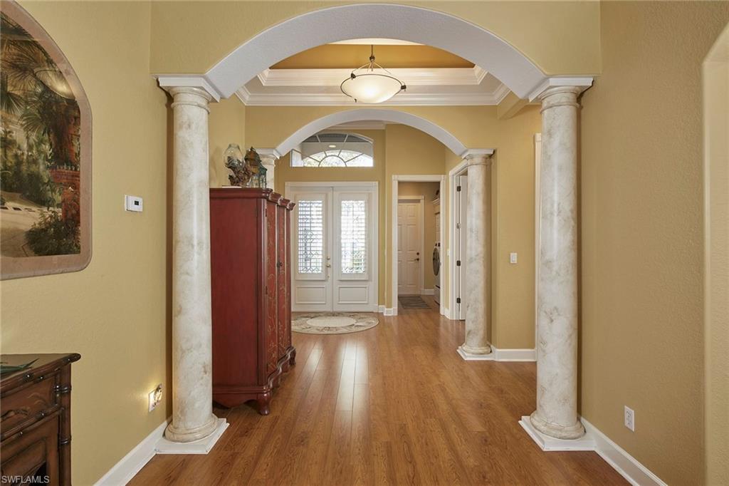 377 Mallory Court Naples, FL 34110 - Photo 19 of 29 an empty room with wooden floor mirror and window