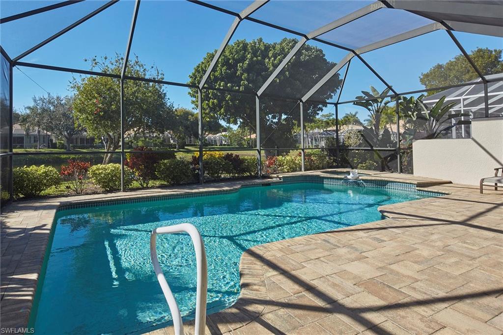 377 Mallory Court Naples, FL 34110 - Photo 23 of 29 a view of a swimming pool with a patio