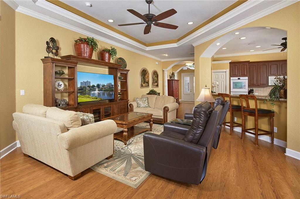 377 Mallory Court Naples, FL 34110 - Photo 6 of 29 a living room with furniture kitchen view and a wooden floor