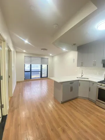 a living room with patio furniture and floor to ceiling window