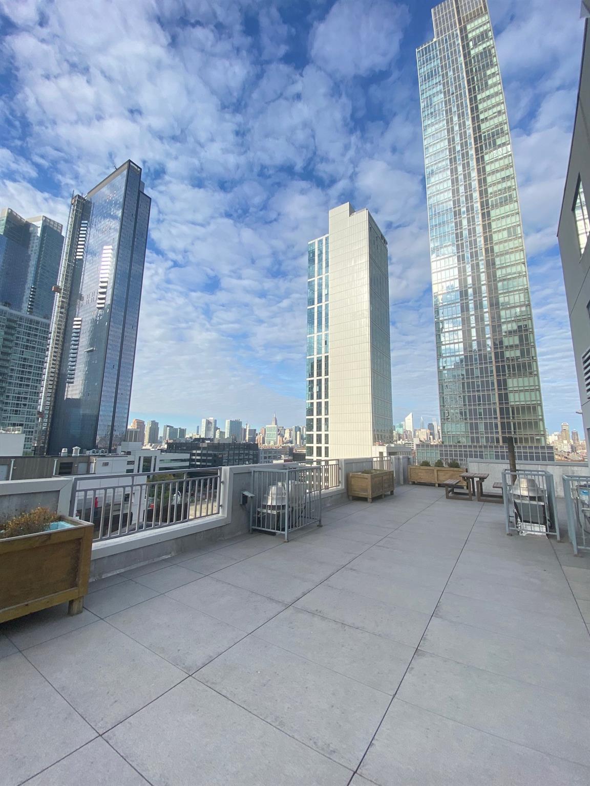 42-22 Crescent Street, Unit 3B Queens, NY 11101 - Photo 7 of 9 a view of hall with couch