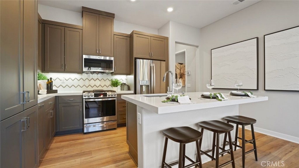 712 Sunrise Road Rancho Mission Viejo, CA 92694 - Photo 1 of 1 a kitchen with stainless steel appliances a stove refrigerator sink and microwave