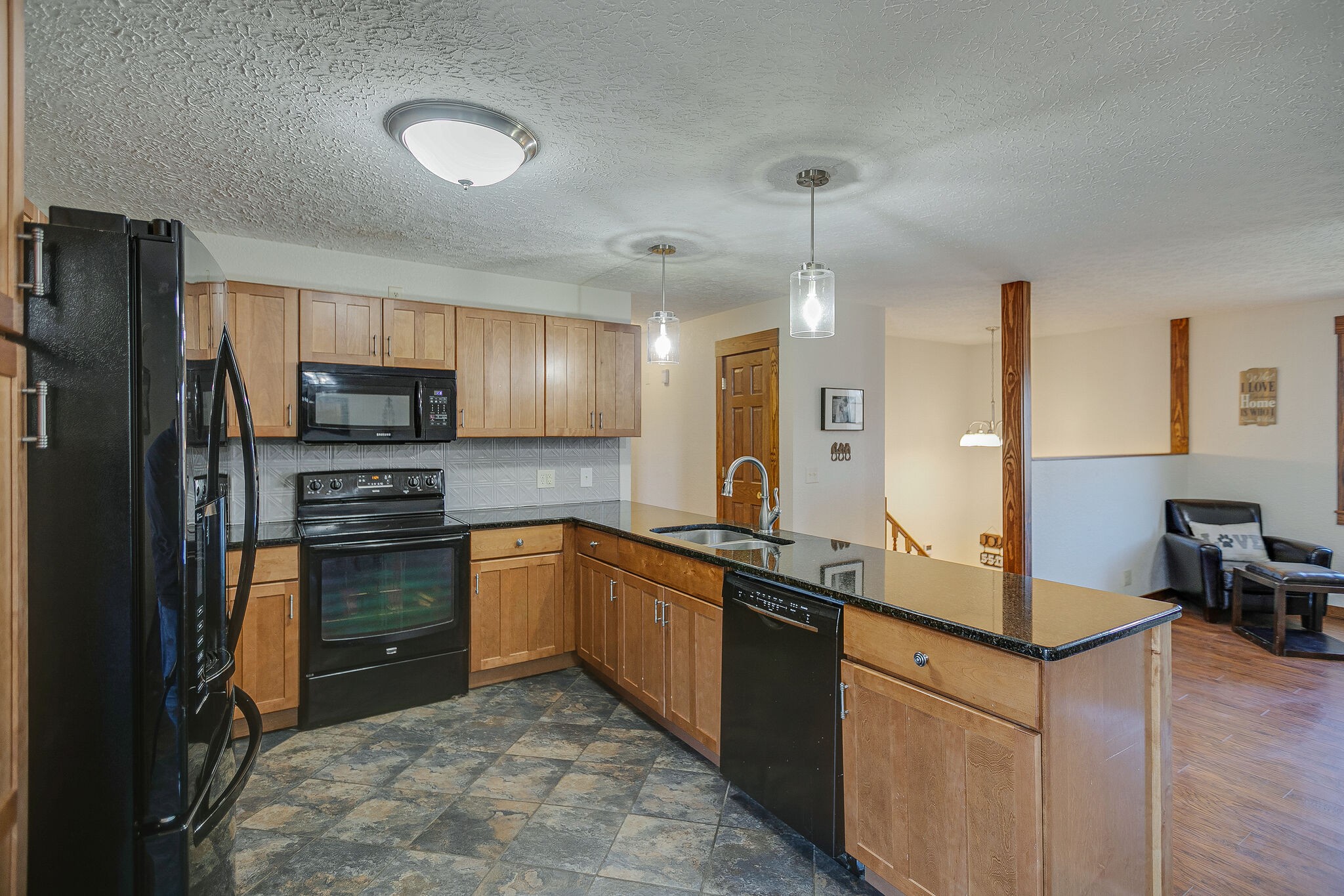 10997 Rials Branch Road Bon Aqua, TN 37025 - Photo 12 of 39 a kitchen with stainless steel appliances granite countertop a sink stove and refrigerator