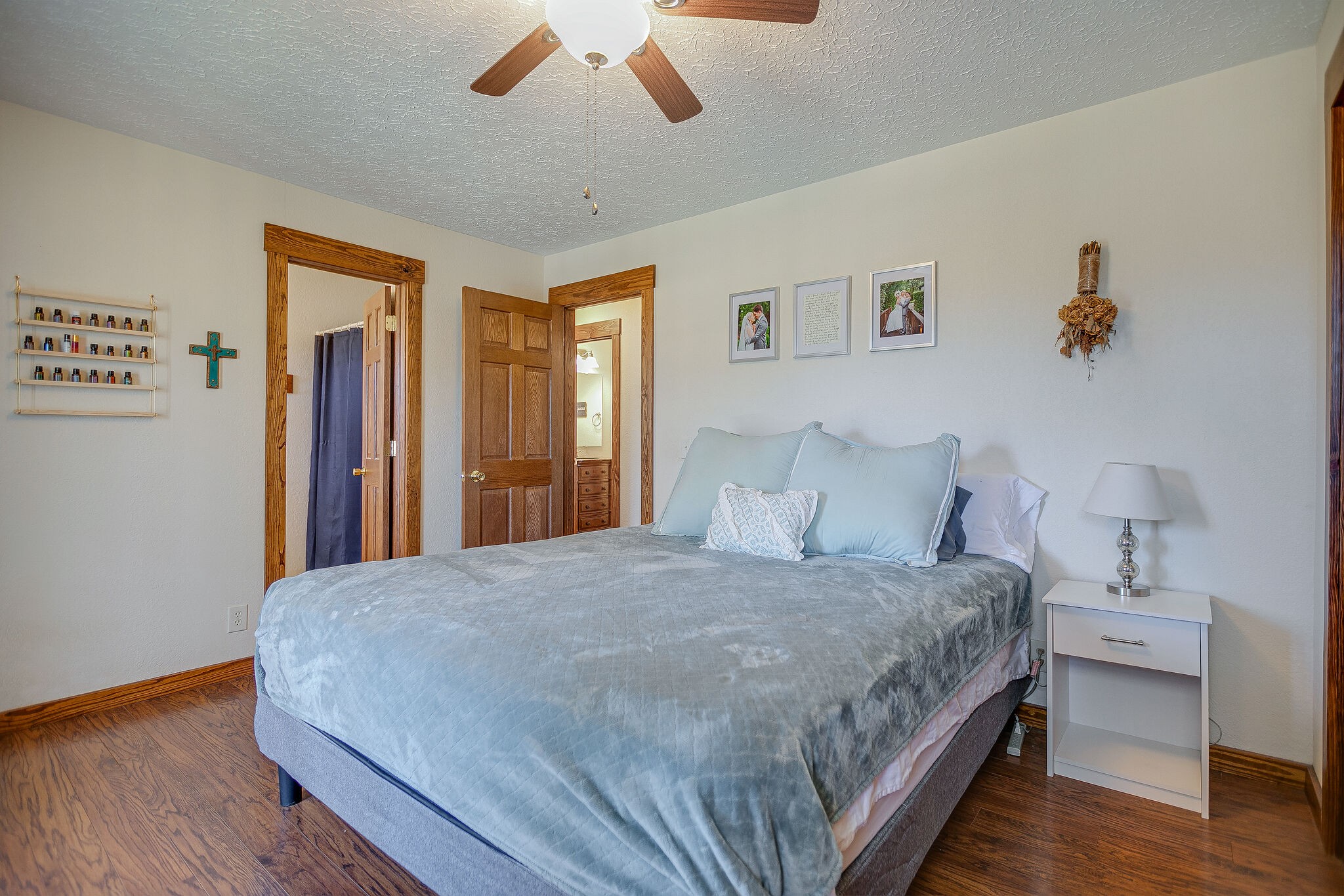 10997 Rials Branch Road Bon Aqua, TN 37025 - Photo 13 of 39 a bedroom with a large bed and a chandelier