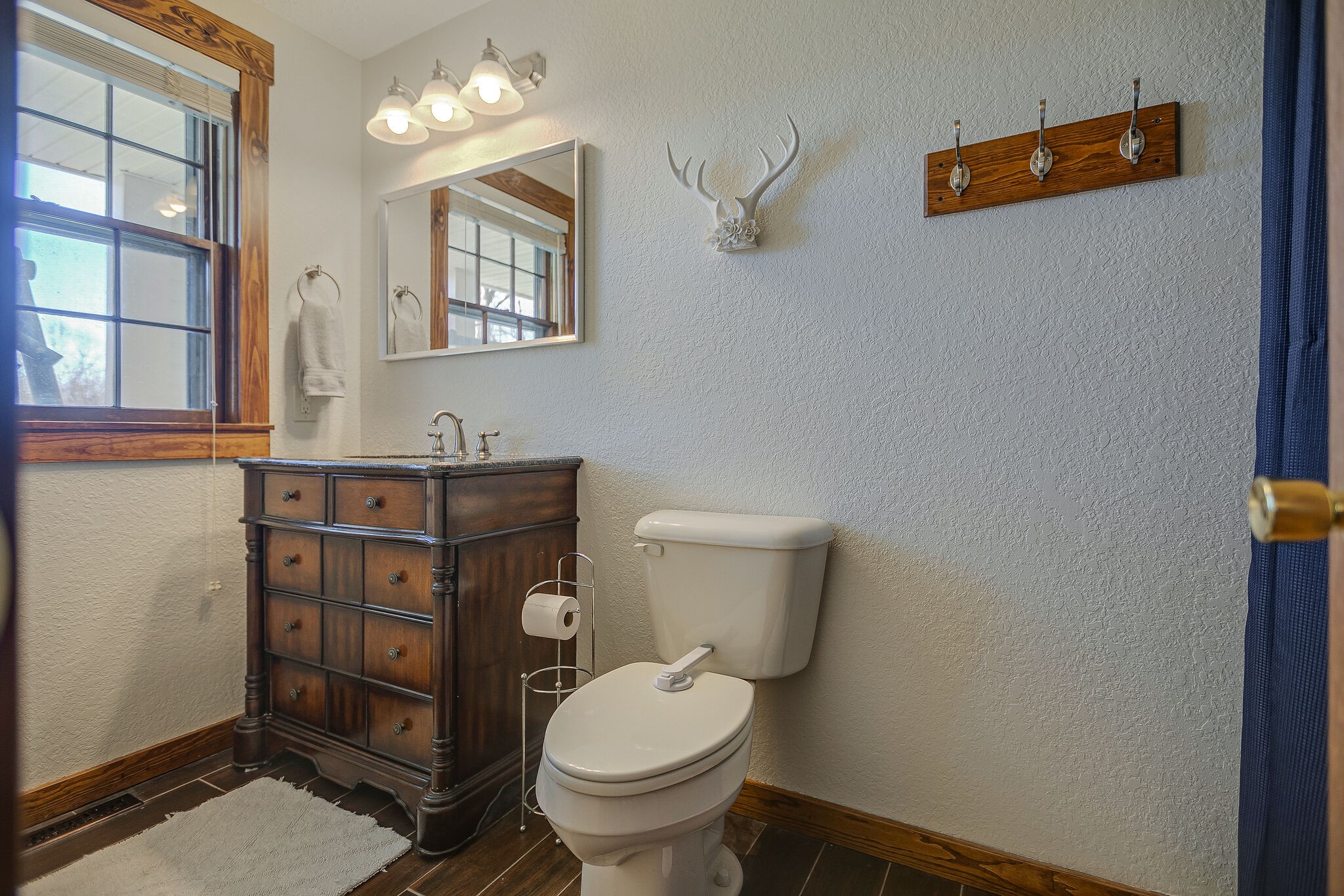 10997 Rials Branch Road Bon Aqua, TN 37025 - Photo 16 of 39 a bathroom with a toilet a sink and mirror