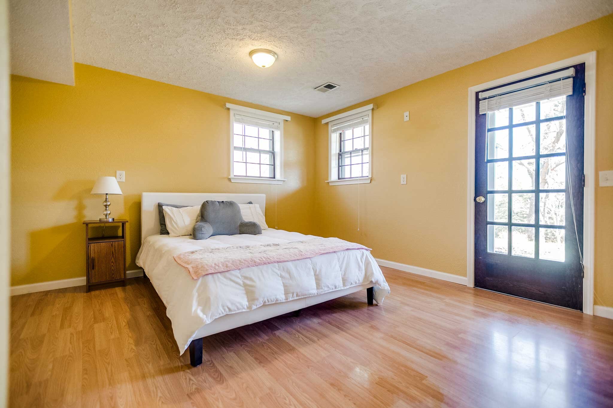 10997 Rials Branch Road Bon Aqua, TN 37025 - Photo 19 of 39 a bedroom with a bed and wooden floor