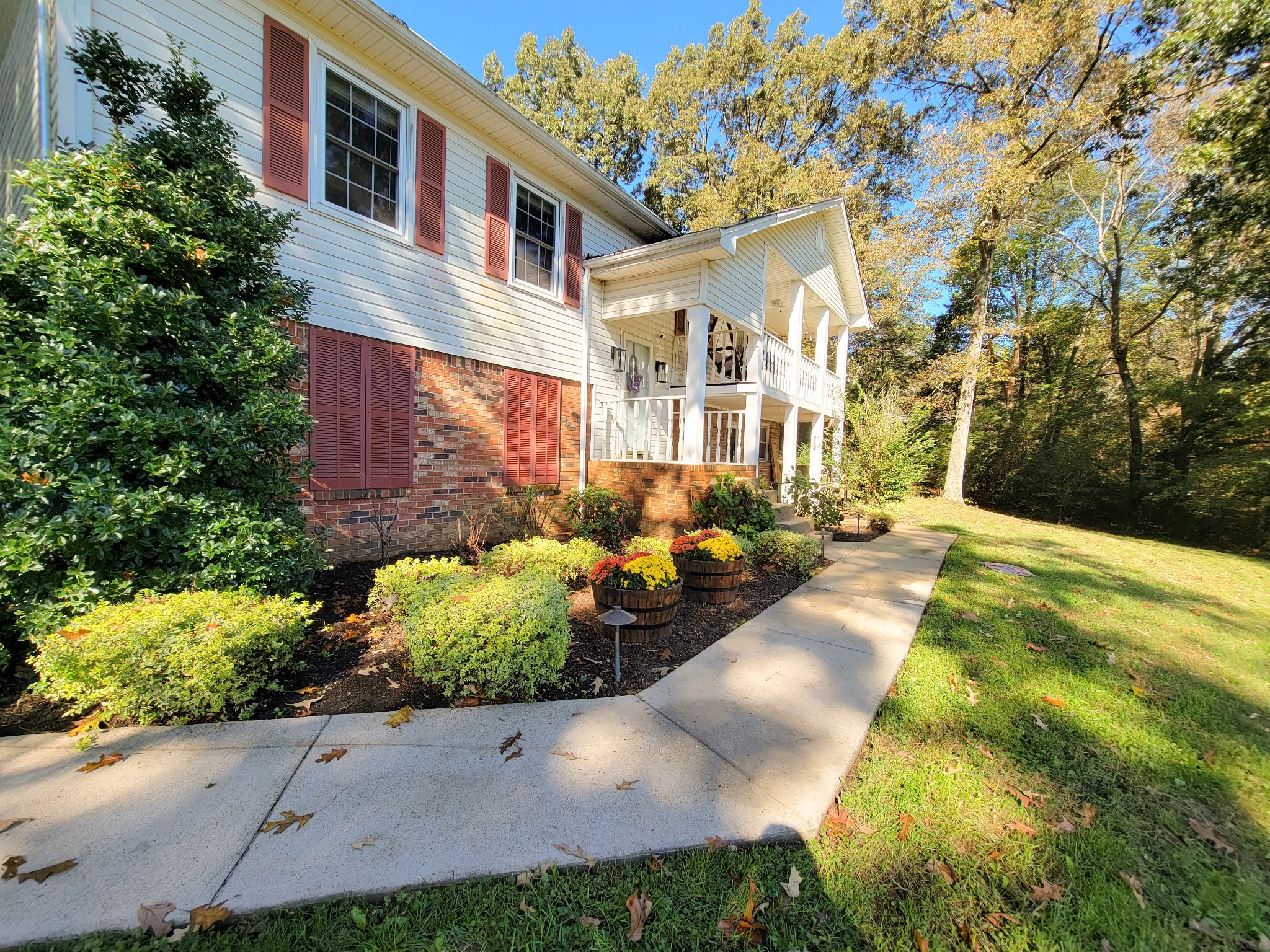 10997 Rials Branch Road Bon Aqua, TN 37025 - Photo 3 of 39 a view of a white house with a yard and potted plants