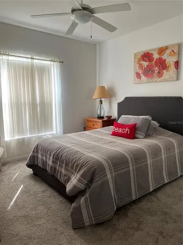 a bedroom with a bed and a painting on the wall