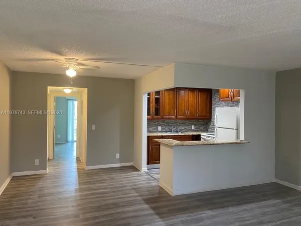 a view of kitchen with kitchen island and stainless steel appliances