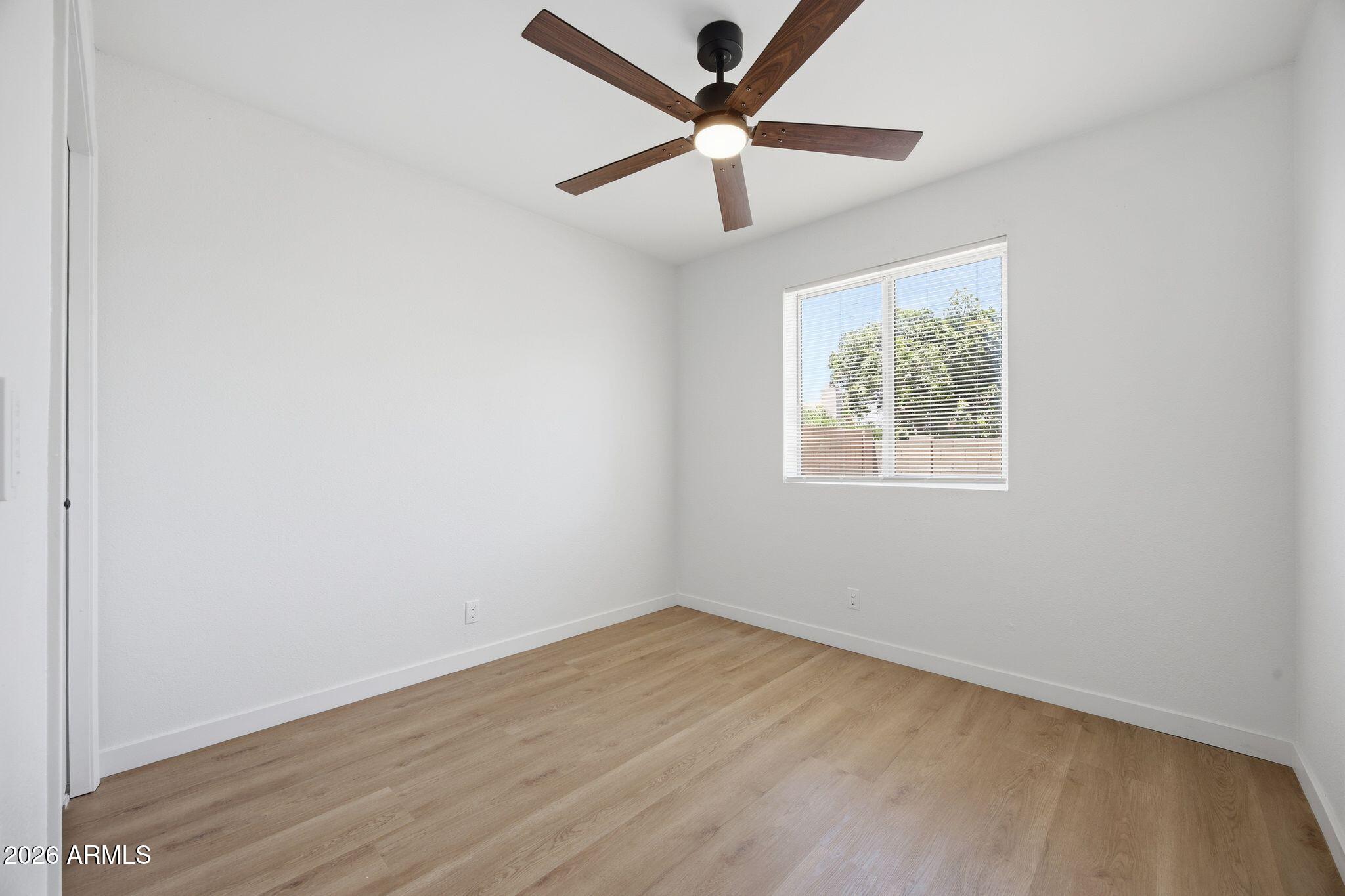 3134 East McKellips Road, Unit 69 Mesa, AZ 85213 - Photo 17 of 24 an empty room with a window and a fan