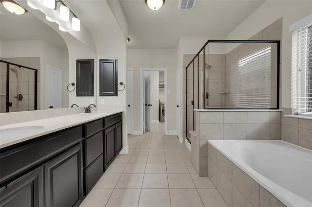 a bedroom with a bed and large window