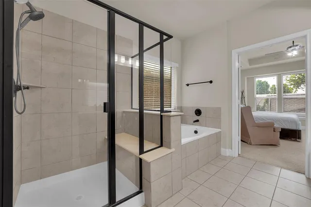 a bathroom with a double vanity sink a large mirror and shower