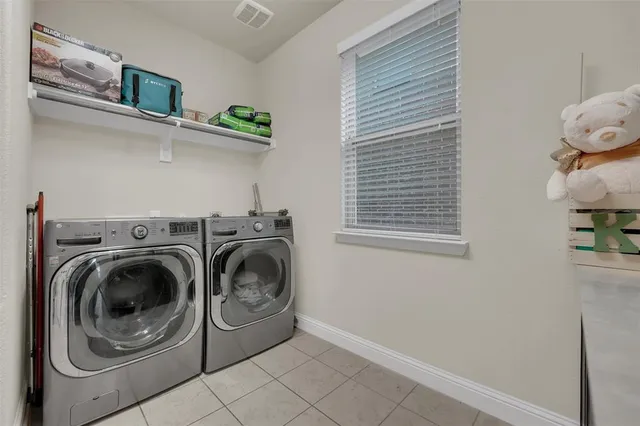 a spacious bathroom with a tub shower and windows