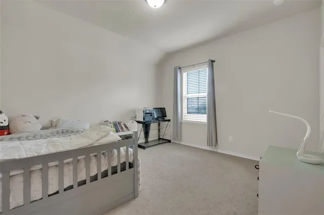 a bed room with a bed and a window