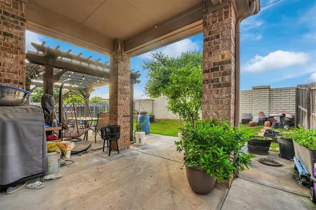 a view of tall trees with a view of the patio