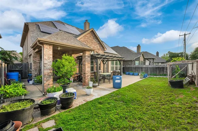 a view of a house with backyard sitting area and garden