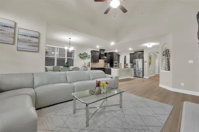 a living room with furniture and a chandelier