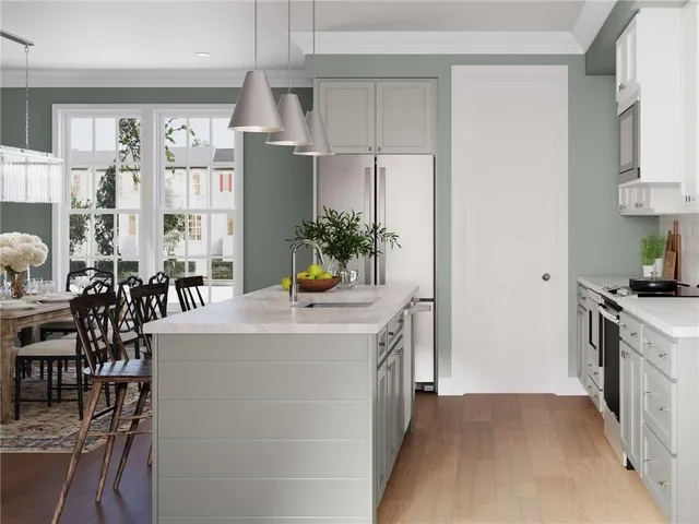 a kitchen with a table chairs sink and cabinets