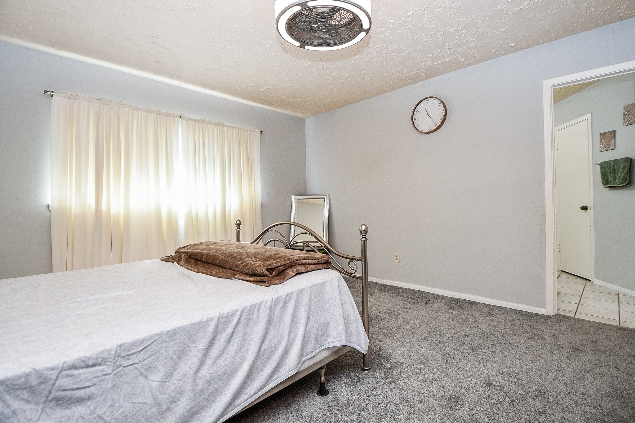 16711 Ribbonridge Drive Sugar Land, TX 77498 - Photo 17 of 24 a bedroom with a bed and a chandelier